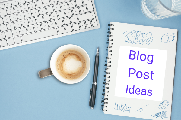 There is a close up of a computer keyboard, a cup of cofee, a pen and noteback with the words Blog Post Ideas on it. The notebook will be filled with ideas for the 10 first blog post ideas for small business owners.